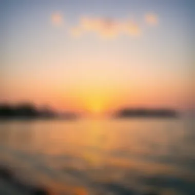 A serene sunset at Al Hudayriat Beach reflecting on the water, symbolizing tranquility.